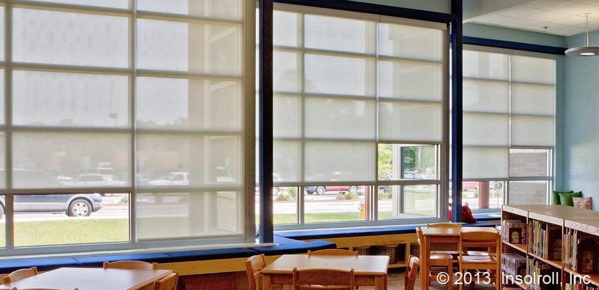 Large clutch-operated solar shades in a South Carolina school library are easy to lift.