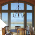 Arched window solar shade in pocket dining room
